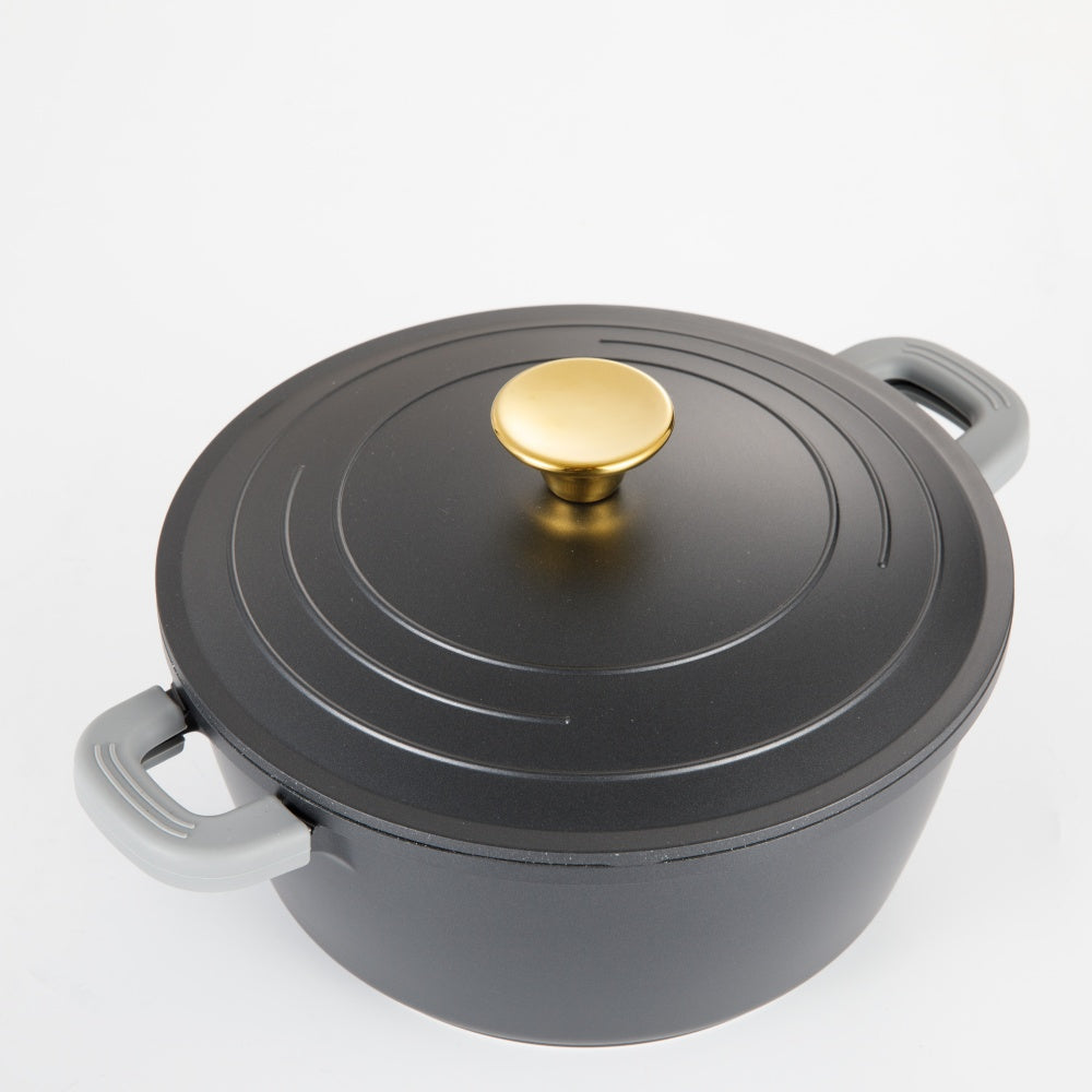Gray pot with a gold lid knob on a white background