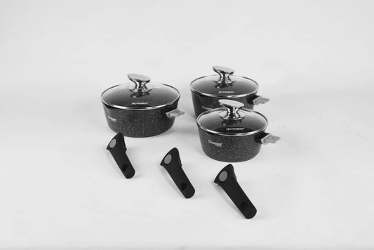 Set of dishes with lids and removable handles on a light gray background