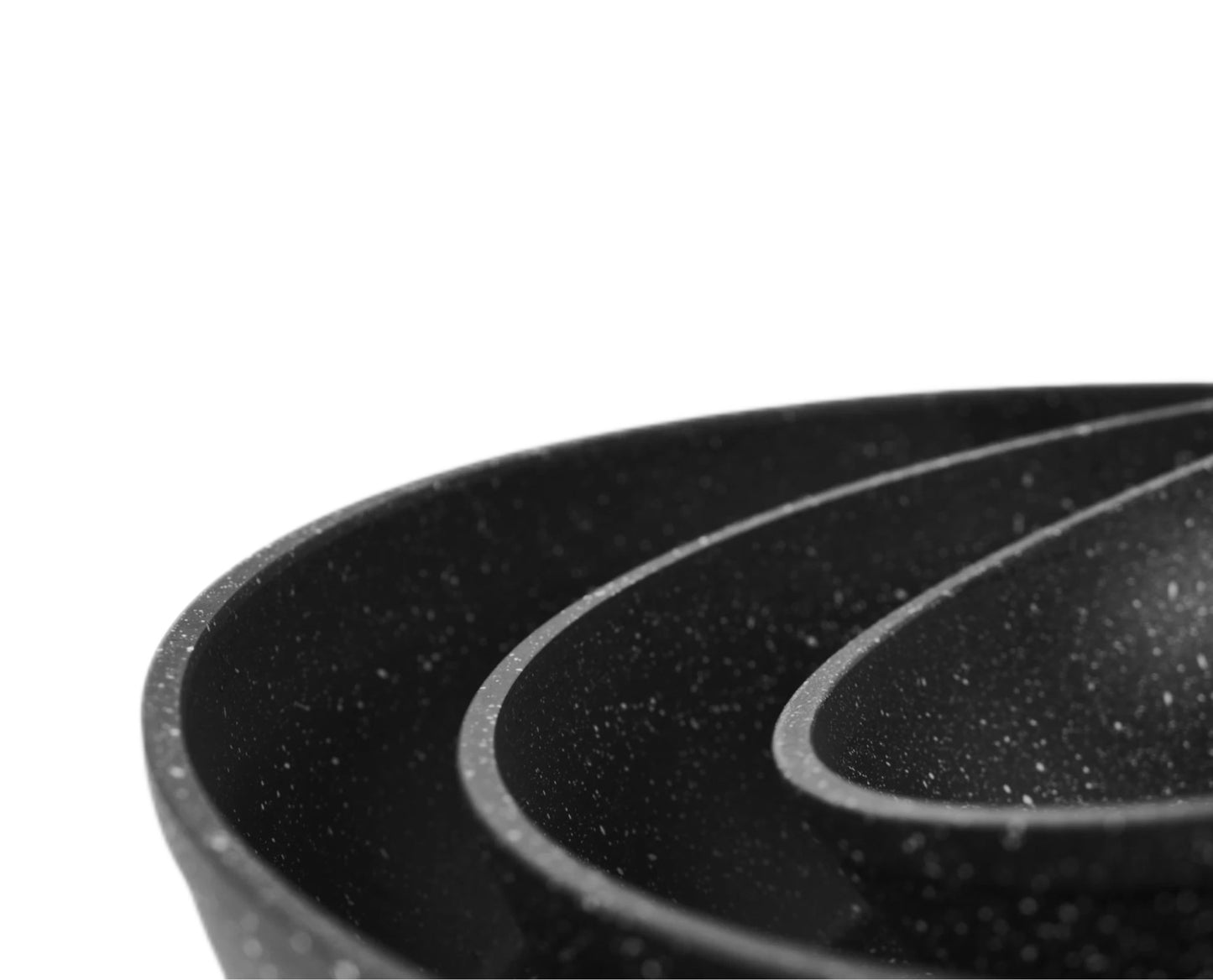 Close-up of a black frying pan with speckled texture on a white background