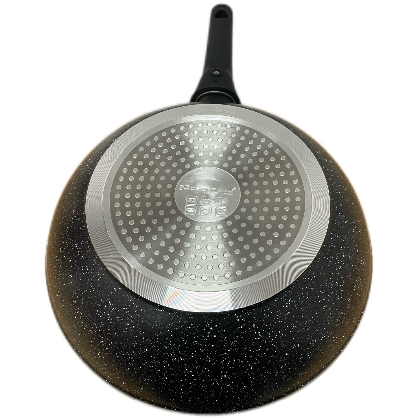 Black speckled frying pan with a silver base on a white background