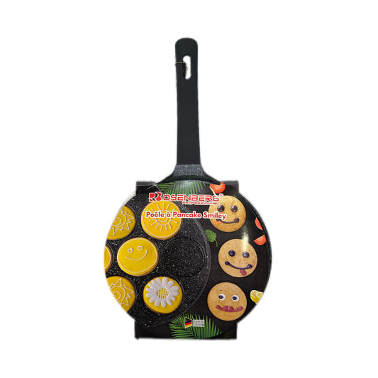 Frying pan with smiley face designs on a white background