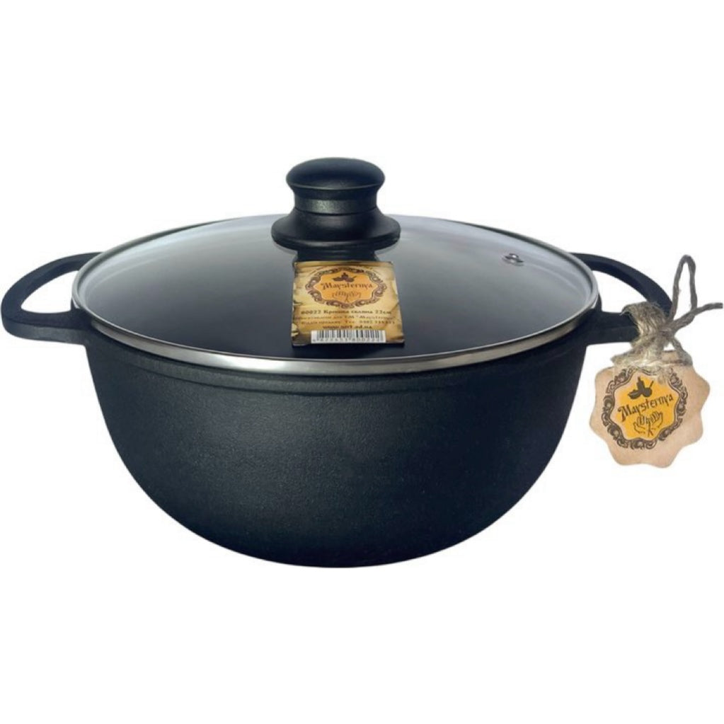 Black cast iron pot with lid on a white background