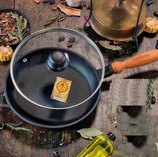 Black cast iron frying pan with wooden handle on a rustic background