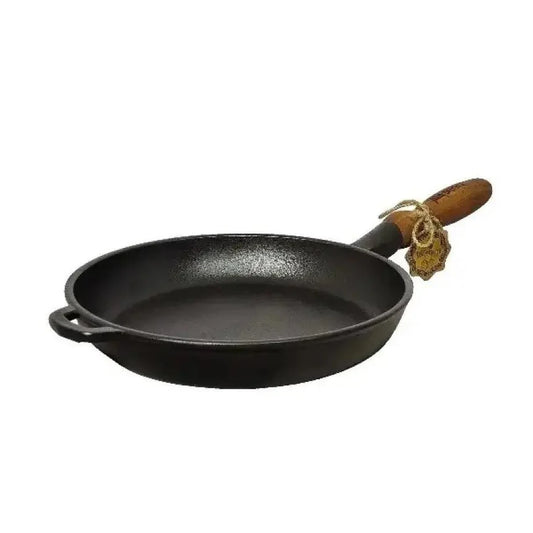Black cast iron frying pan with a wooden handle on a white background