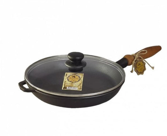 Black cast iron frying pan with wooden handle on a white background