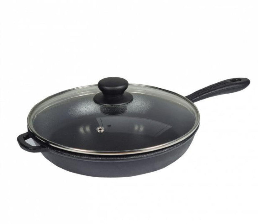 Black cast iron frying pan with glass lid on a white background