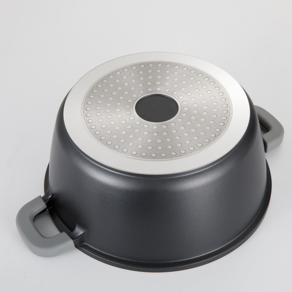 Black pot with a perforated lid on a light gray background