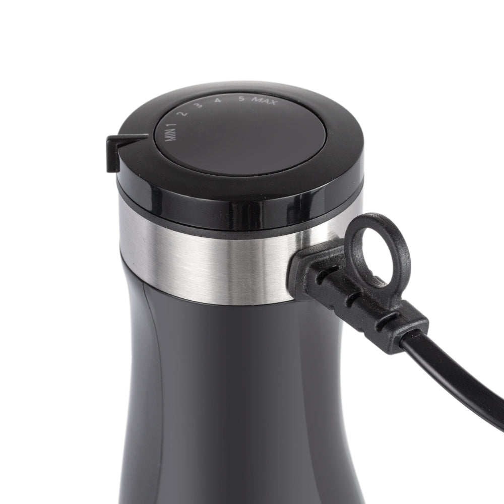 Black and silver electric kettle with control dial on a white background