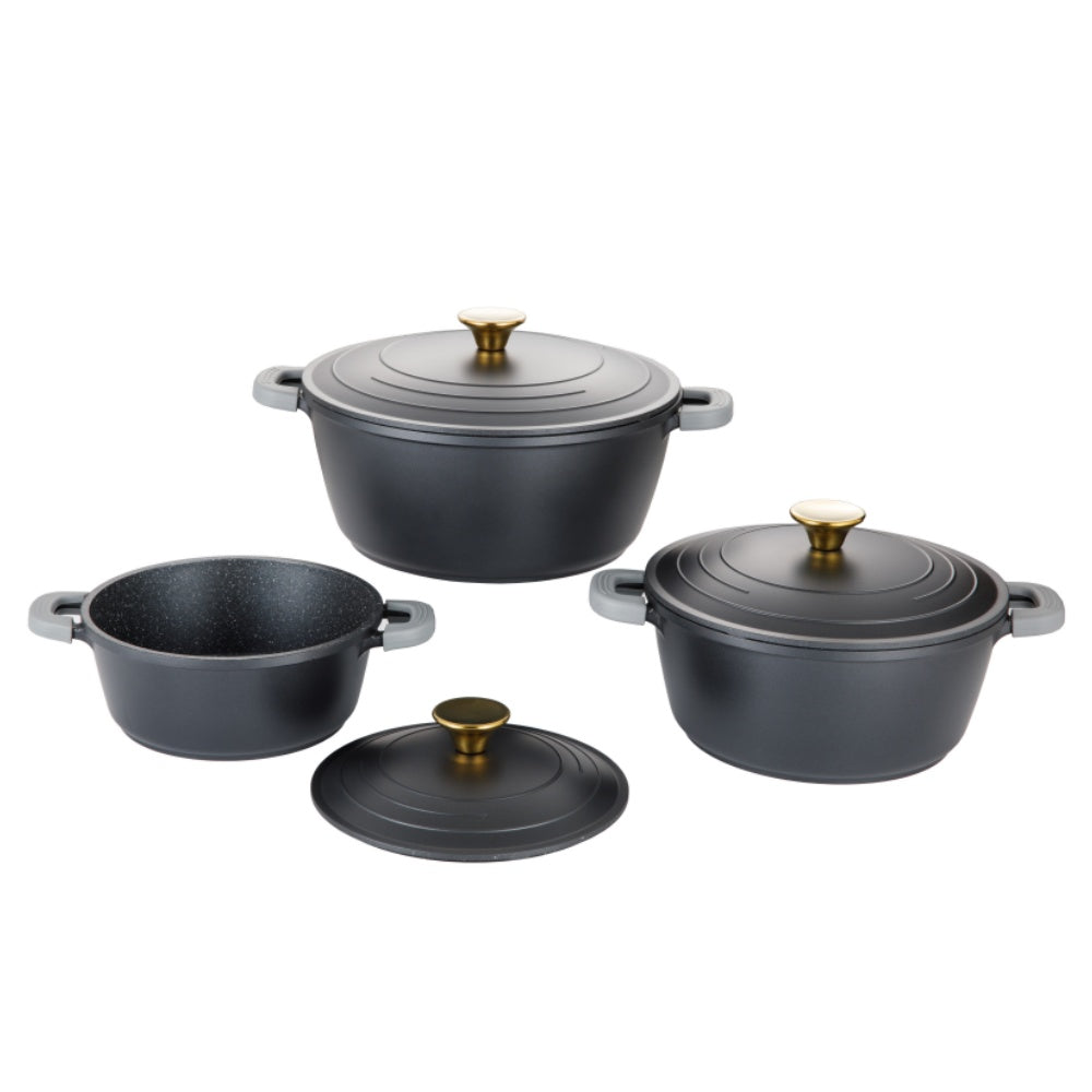 Set of black cookware with gold lids on a white background