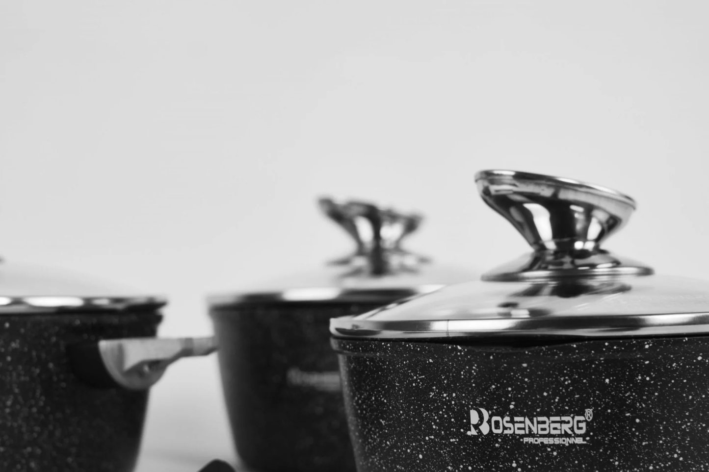 Black speckled cookware set with 'Rosenberg' branding on a light background