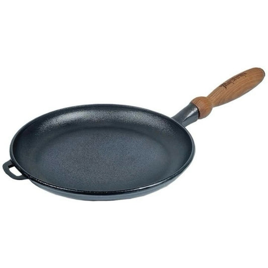 Black cast iron pancake pan with a wooden handle on a white background
