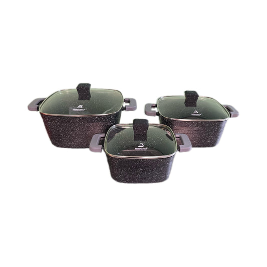 Set of three black speckled cookware pots with lids on a white background
