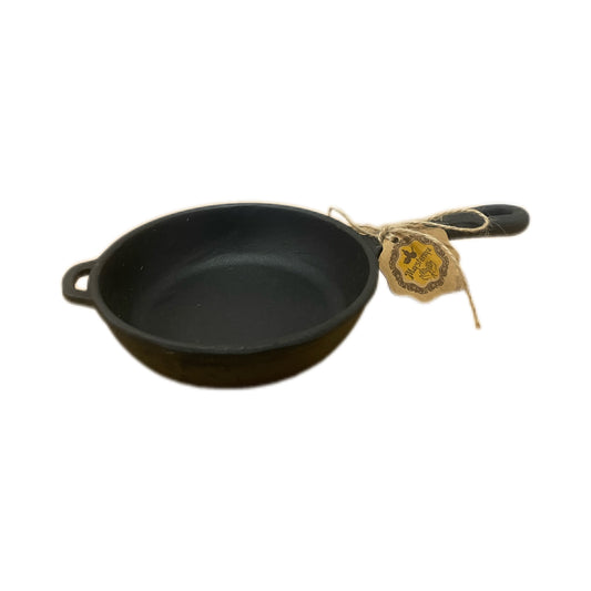 Small black cast iron skillet with a handle on a white background