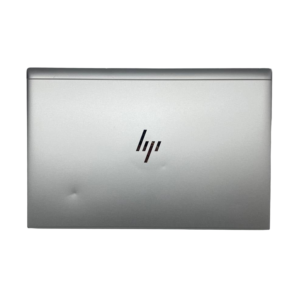 Silver HP laptop on a gray background