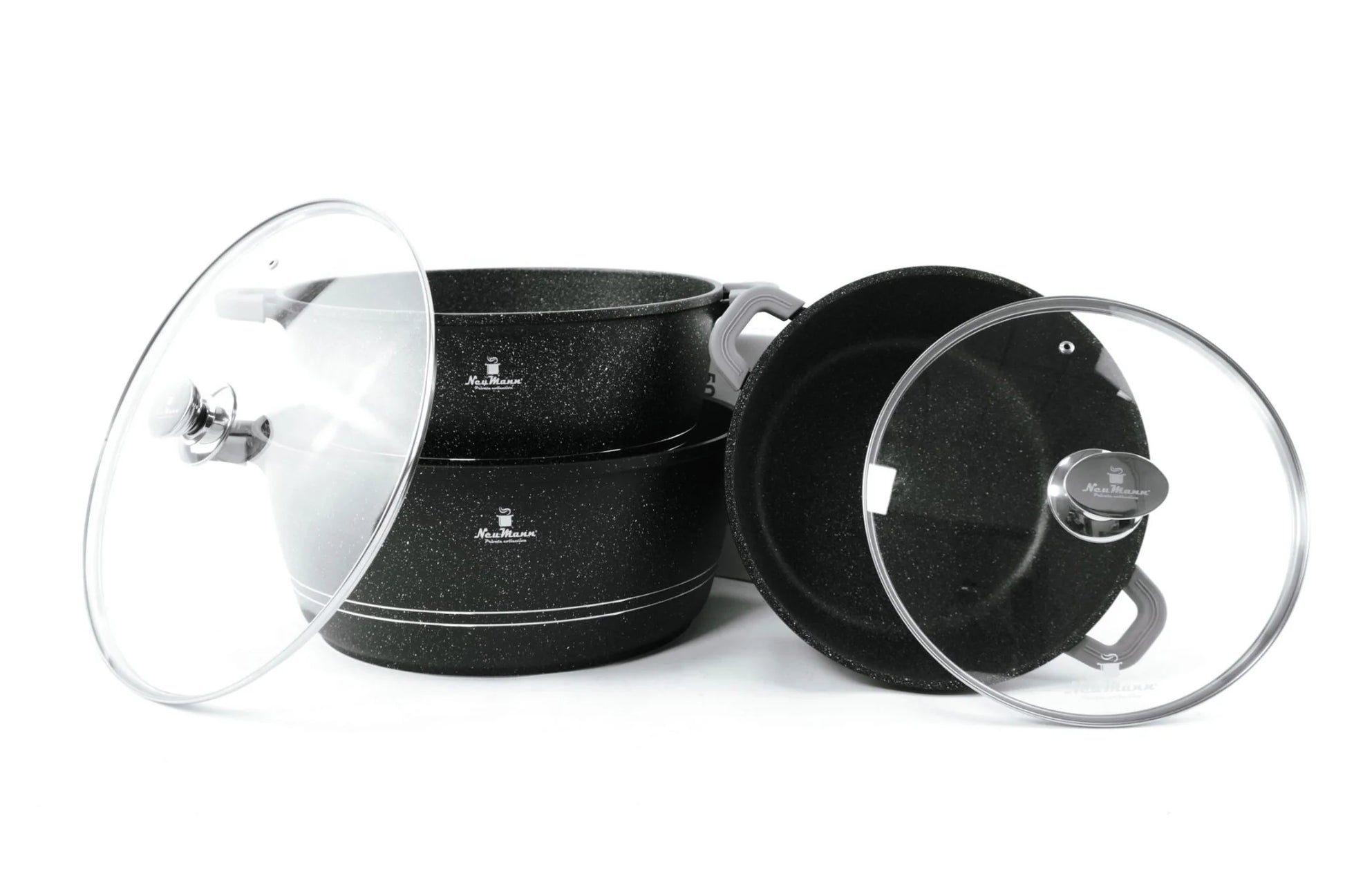 Set of black cookware with glass lids on a white background