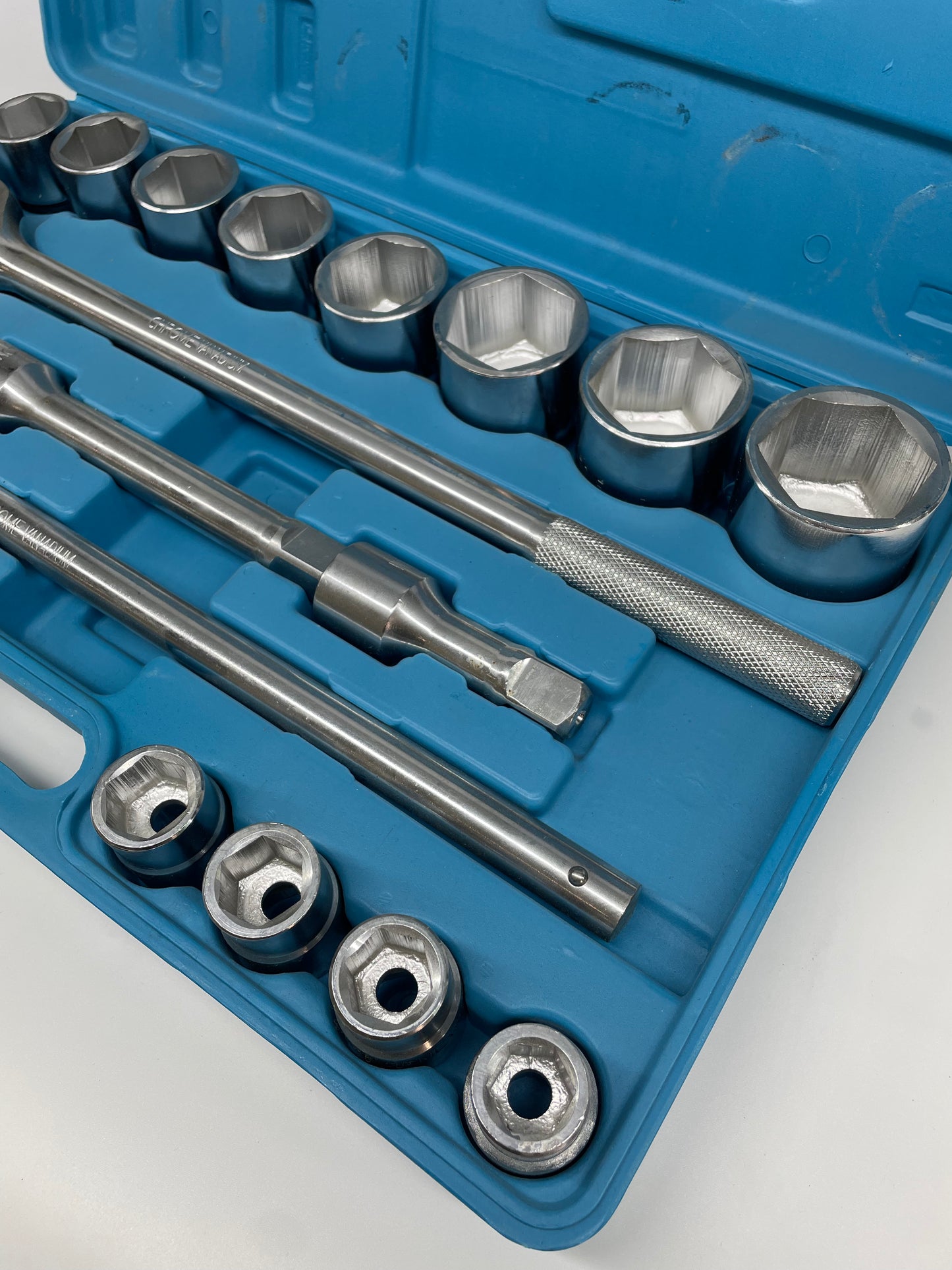 Socket set with tools in a blue case on a white background