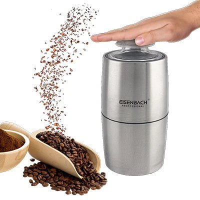 Stainless steel coffee grinder with coffee beans and a scoop on a white background