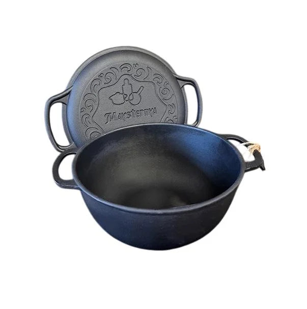 Black cast iron pot with lid on a white background
