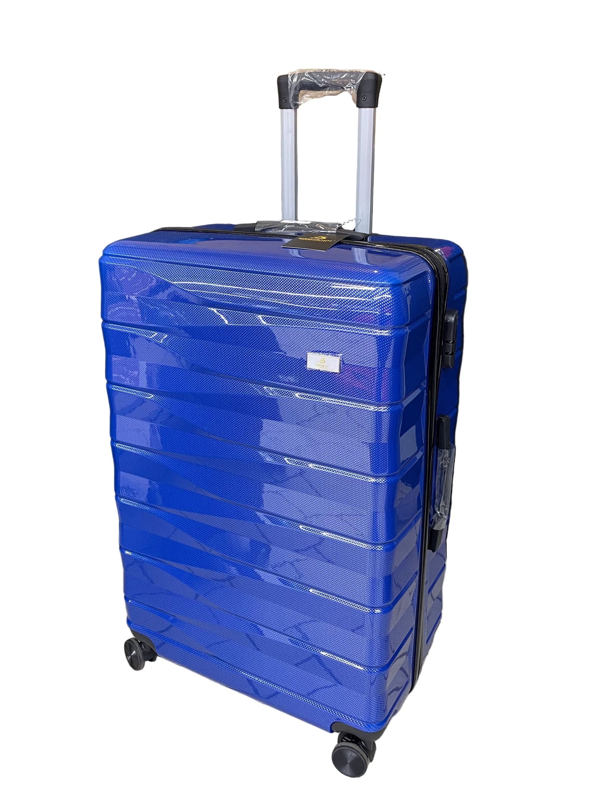 Blue suitcase on a tiled floor with a black backdrop