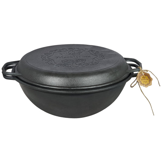Black cast iron Dutch oven with lid on a white background