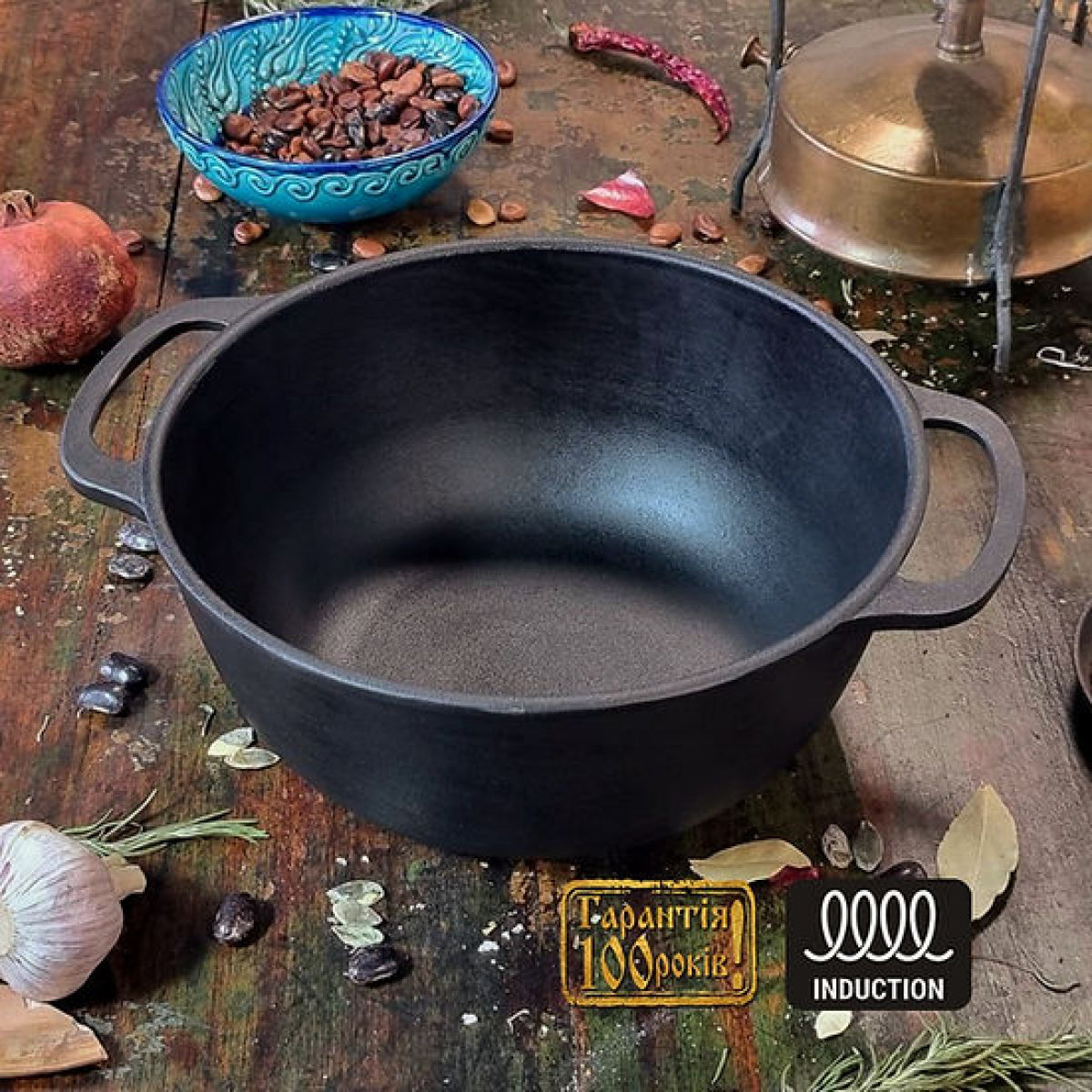 Black cast iron pot on a rustic wooden surface with ingredients and a brand logo.