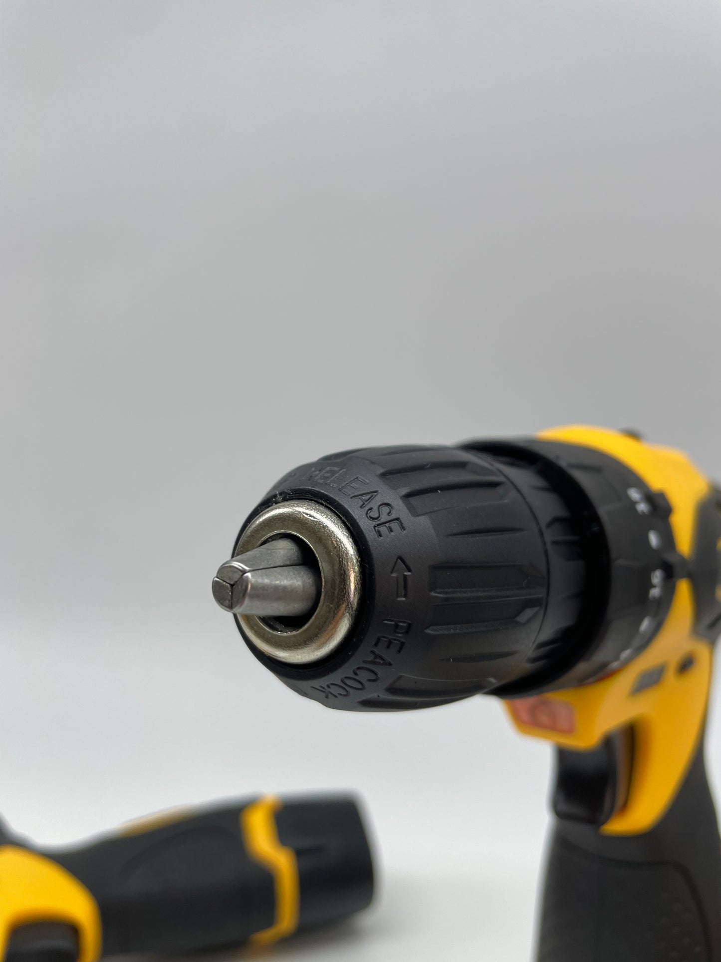Black and yellow cordless drill on a white background