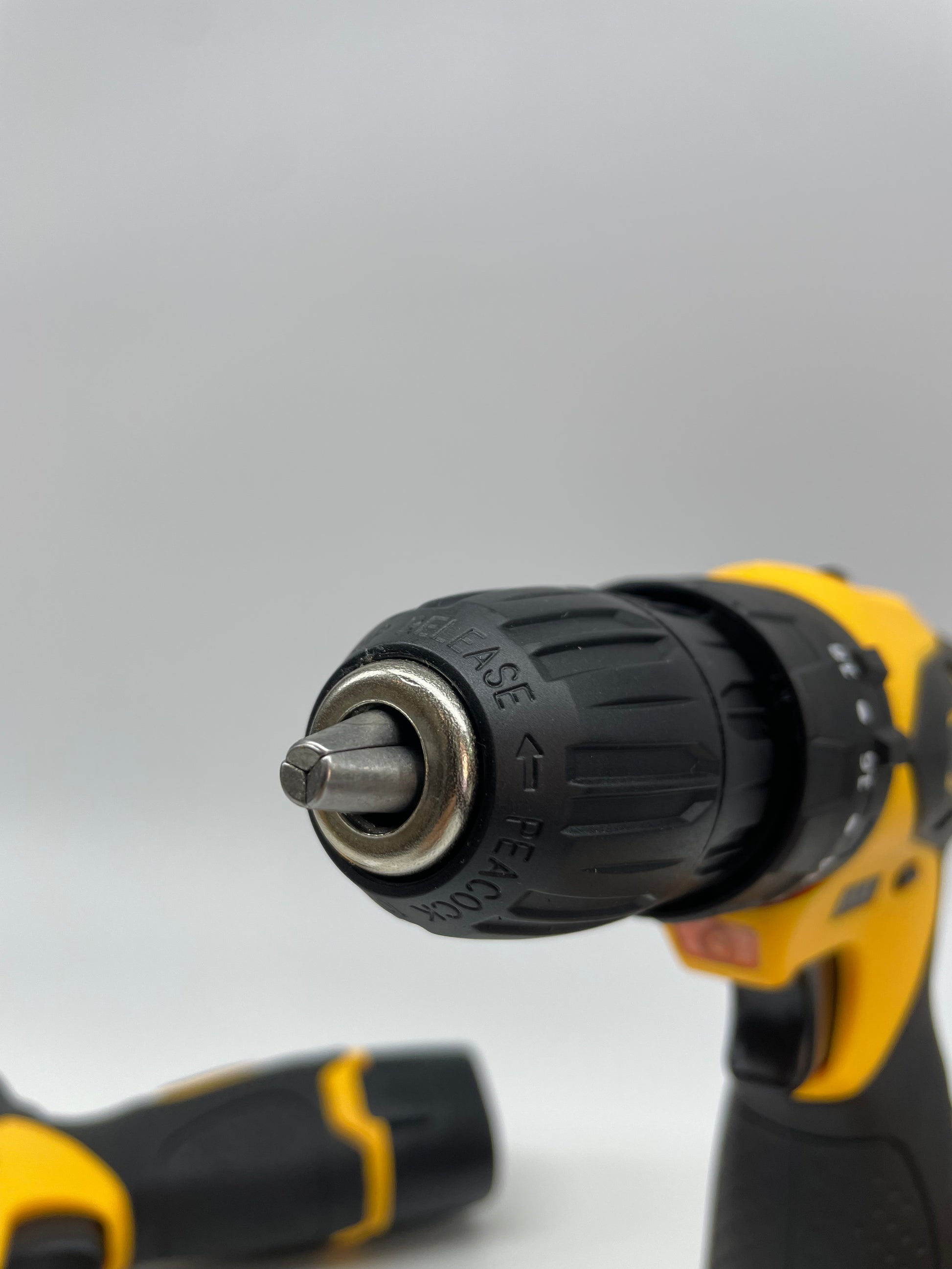 Black and yellow cordless drill on a white background