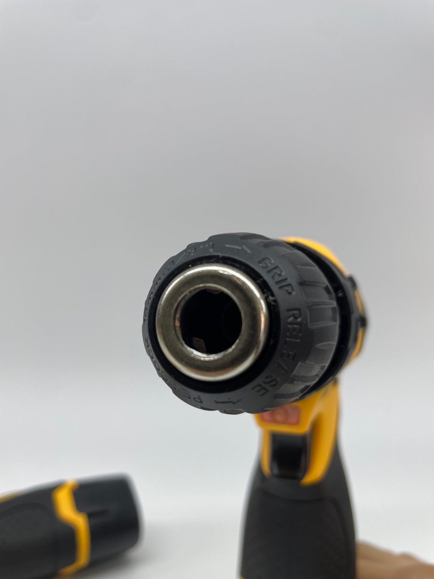 Close-up of a black and yellow screwdriver bit on a white background