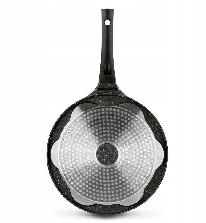Black frying pan with textured bottom on a white background