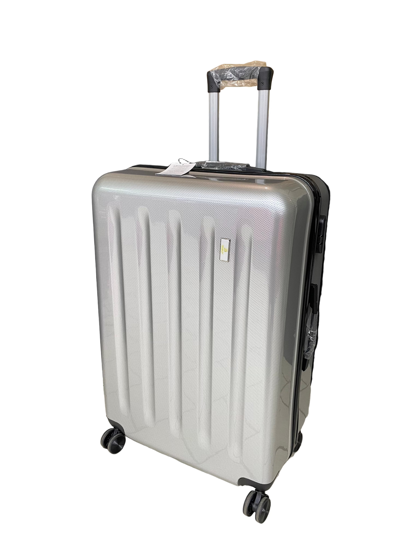 Silver suitcase on a tiled floor with a black backdrop